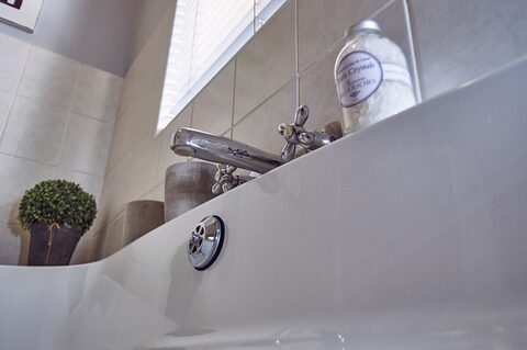 Bath taps and guest toiletries detail