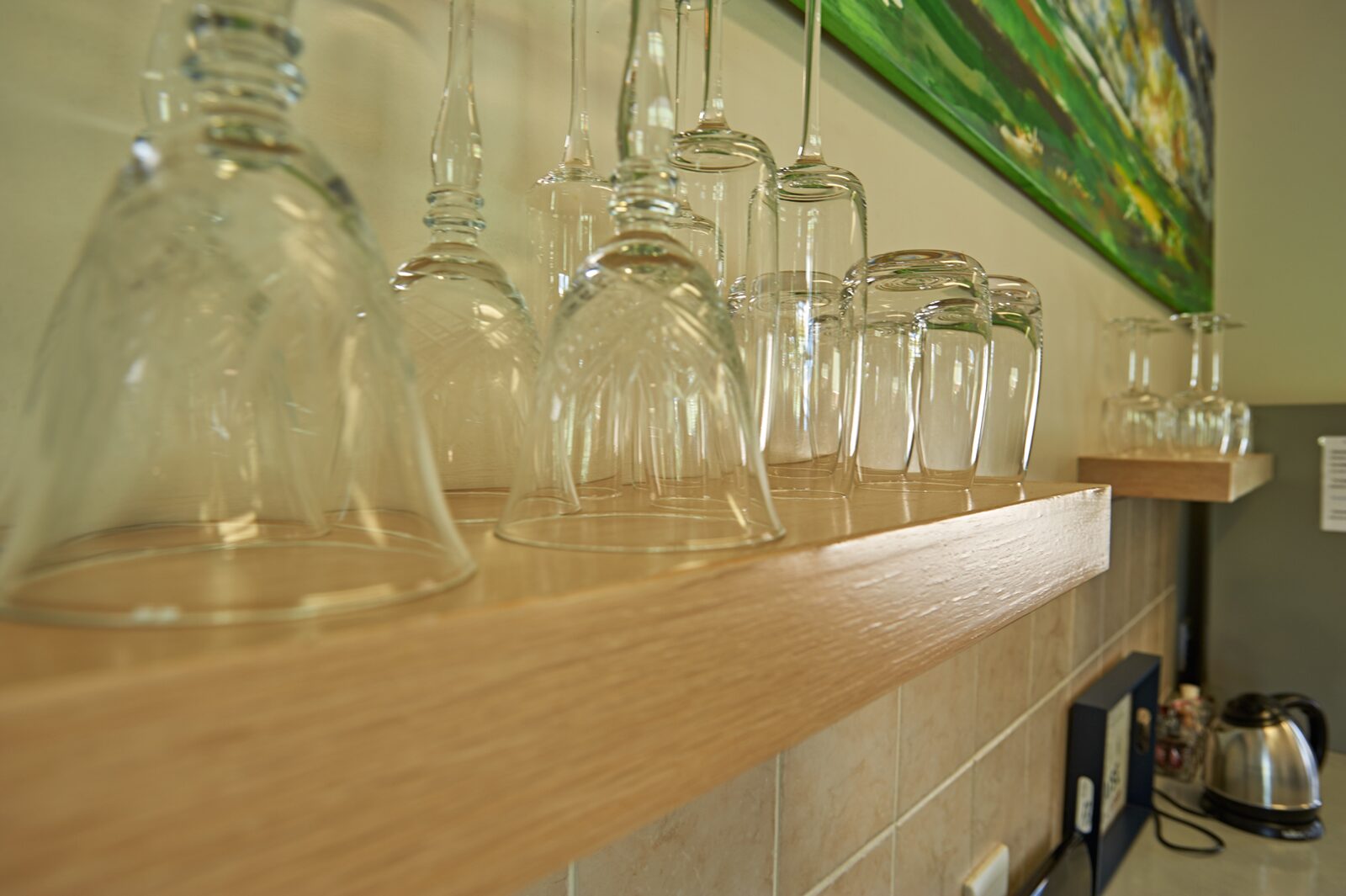 Wine glasses on a shelf in the kitchen at Stay in Clarens