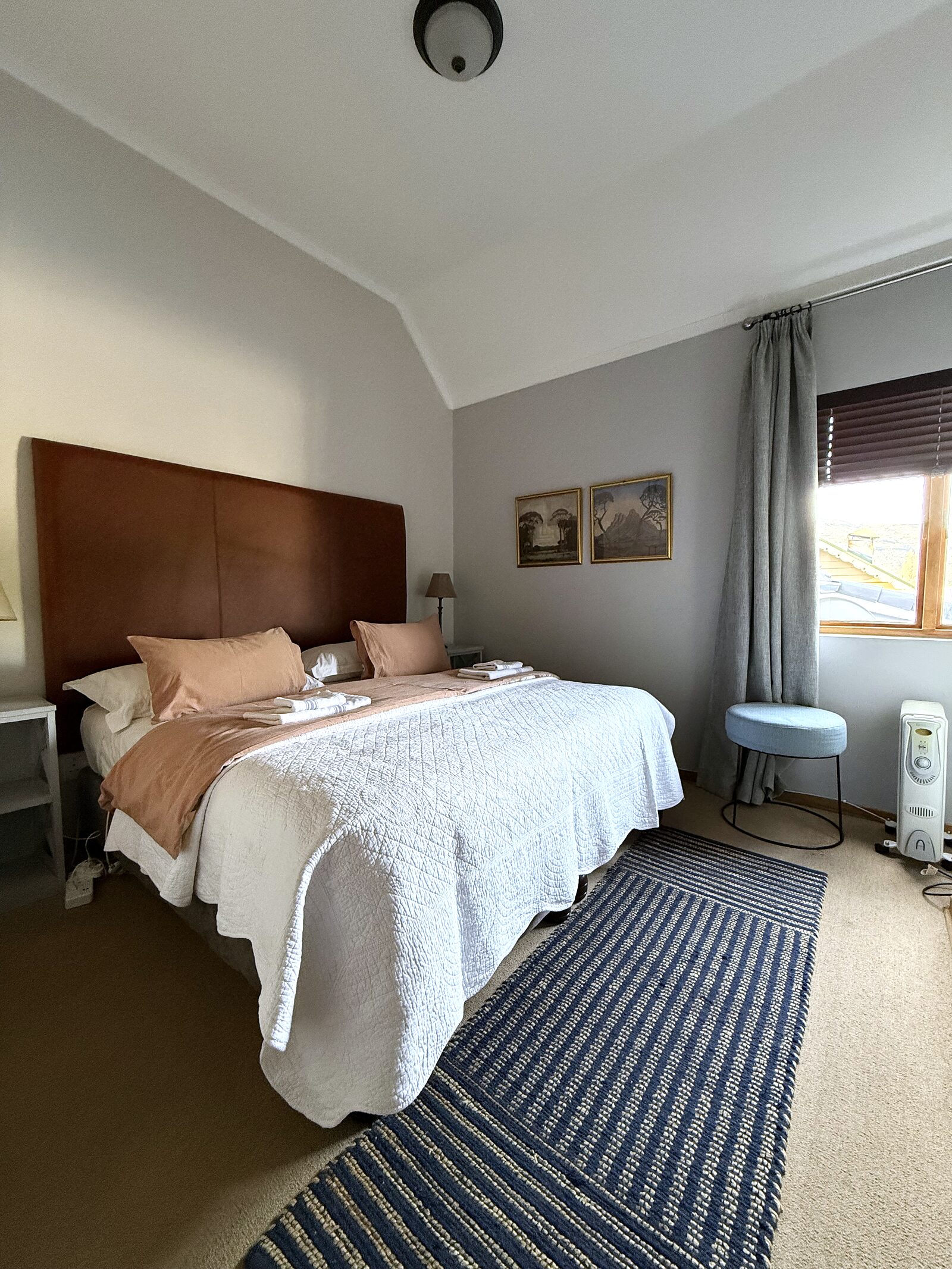 Second bedroom in The Loft with a king bed and striped rug