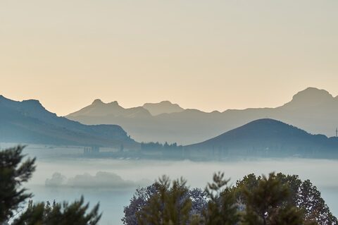 Mist layering between ridges of the Maluti Mountains above Clarens at dawn