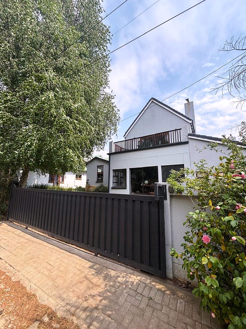 The motorised security gate closed across the driveway