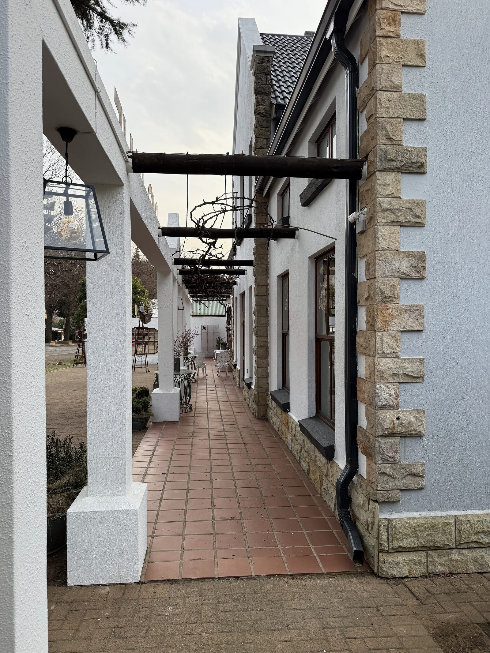 The covered sandstone walkway alongside the shop