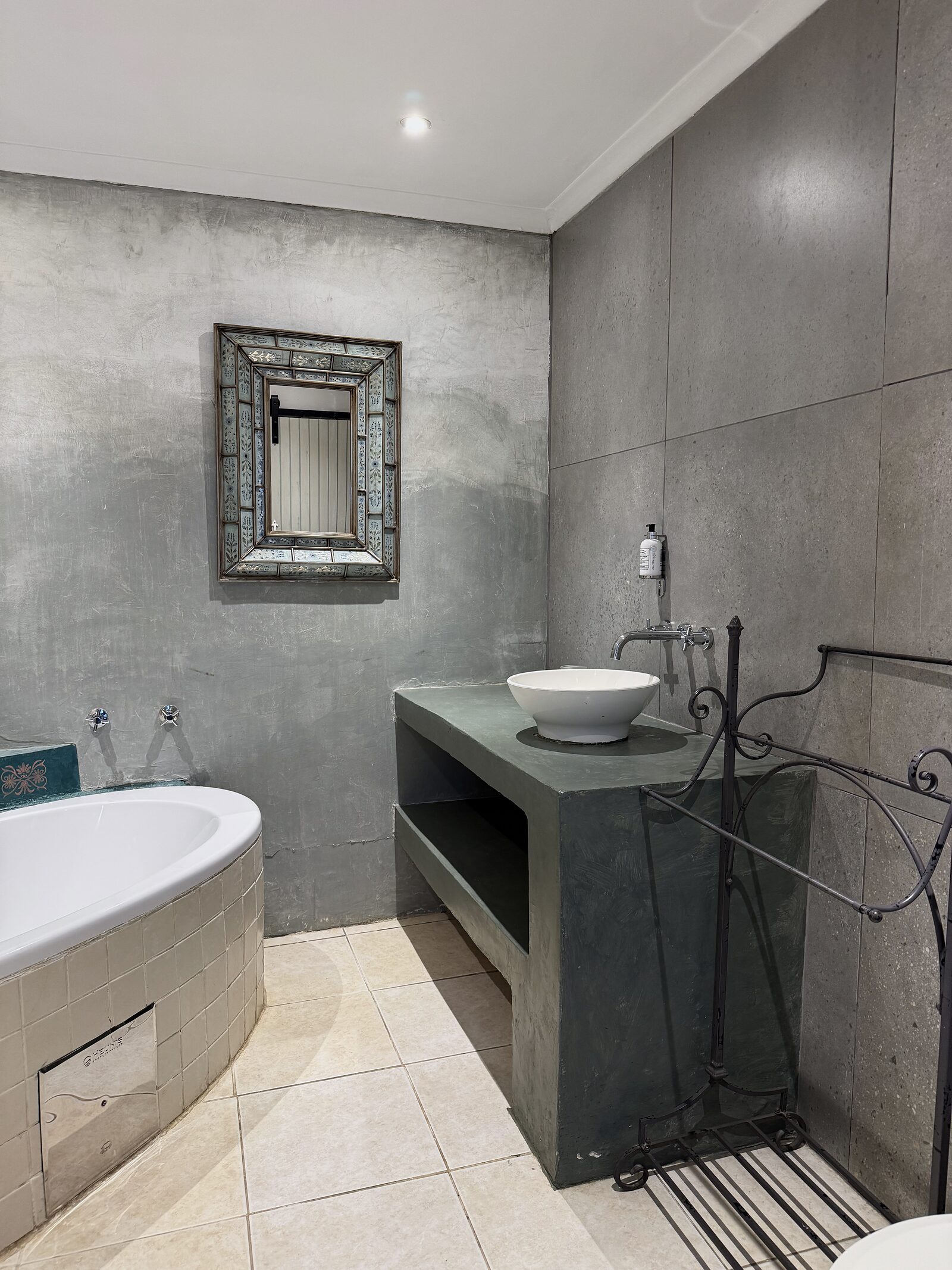 Bathroom in The Studio with stone basin, shower and corner bath
