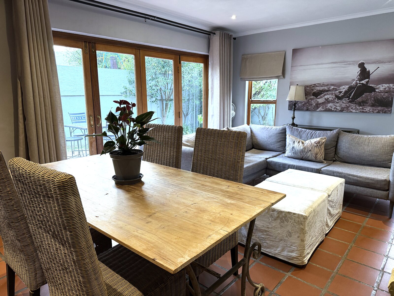 Dining table in The Studio with glass stack doors folded open to the patio